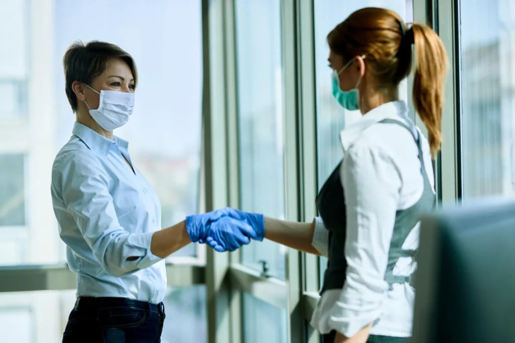 pest control staff shaking hand with client